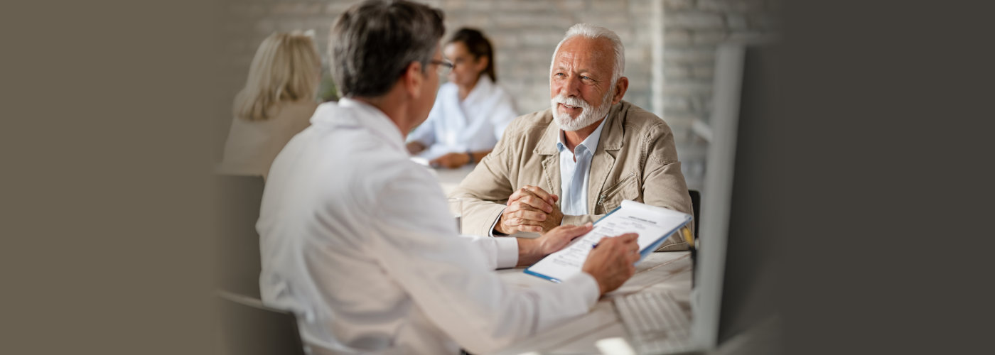 elderly man talking to health expert